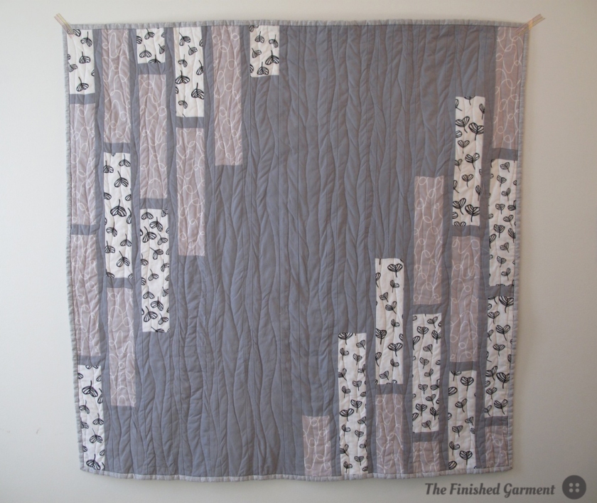 A monochromatic baby quilt sewn by The Finished Garment.