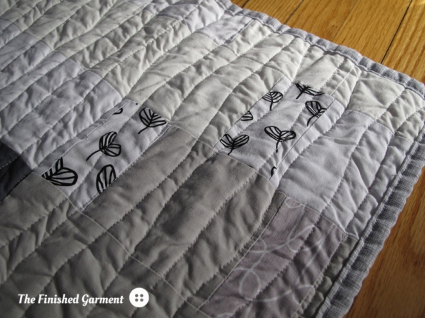 A monochromatic baby quilt sewn by The Finished Garment.